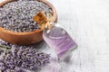 Glass bottle of Lavender essential oil with fresh lavender flowers and dried lavender seeds on white rustic table Royalty Free Stock Photo