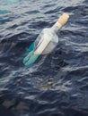 Glass bottle with letter in the sea Royalty Free Stock Photo