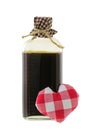 A glass bottle of love potion in brown with a red gingham heart Royalty Free Stock Photo