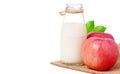 Glass bottle milk and red apple on hemp fabric bag Royalty Free Stock Photo