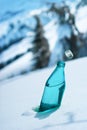 Glass bottle of mineral water on the backdrop of Alpine scenery Royalty Free Stock Photo