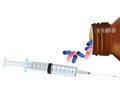 Glass bottle overturned colored pills syringe