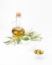 Glass bottle of premium virgin olive oil and herbs.