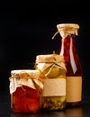 Glass bottle with preserved food on black background Royalty Free Stock Photo