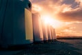 Glass bottle recycling facility at sunrise.Raw of plastic containers for glass collection. Warm sunrise time. Sun flare. Nobody