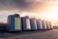 Glass bottle recycling facility at sunrise.Raw of plastic containers for glass collection. Warm sunrise time. Sun flare. Nobody