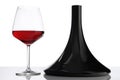 Glass and bottle of red wine decanter on white