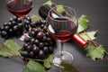 Glass and bottle of red wine and fresh ripe juicy grapes table Royalty Free Stock Photo