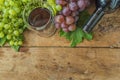 Glass and bottle of red wine, grapes with leaves Royalty Free Stock Photo