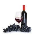 Glass and bottle of red wine with ripe grapes on white background Royalty Free Stock Photo