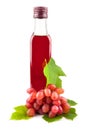 Glass bottle of red wine vinegar with grapes Royalty Free Stock Photo