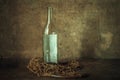Glass bottle of Russian vodka in a bag net on a wooden table Royalty Free Stock Photo
