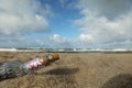 Glass bottle with SOS message on sand near sea, space for text Royalty Free Stock Photo