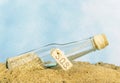 A glass bottle with SOS in sand Royalty Free Stock Photo