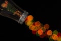 Glass bottle spilling beautiful bokeh