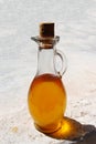Glass bottle stoppered with Argan oil. Royalty Free Stock Photo