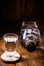 Glass and bottle of strong distilled alcohol, brandy, sugar cane-based drink, distilled alcoholic drink, pure, high alcohol
