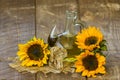 Glass bottle with sunflower oil and sunflowers Royalty Free Stock Photo