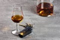 Glass and bottle of whiskey on a stone table top and car keys. Driving in drunkenness Royalty Free Stock Photo