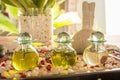 Glass bottles with aromatic oil and flowers on the wooden table at the SPA Royalty Free Stock Photo