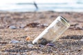 A glass bottles on the beach near the sea. It is garbage pollutio Royalty Free Stock Photo