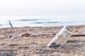 A glass bottles on the beach near the sea. It`s garbage pollutio Royalty Free Stock Photo