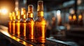 Bottles of Beer on Production Line With Sunlight Highlighting Their Shapes and Colors at a Brewery Plant Royalty Free Stock Photo