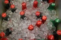 Glass bottles of CocaCola and Sprite surrounded by ice cubes