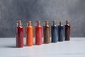 Glass bottles with different food coloring on white marble table Royalty Free Stock Photo