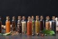 Glass bottles with different spices on table Royalty Free Stock Photo