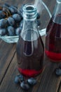 Glass bottles of fresh grape juice Royalty Free Stock Photo