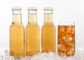 Glass bottles and glass with drink with ice Royalty Free Stock Photo