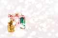 Glass bottles with glitter confetti on white background with bokeh lights. Holiday Christmas and New Year background