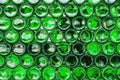 Glass bottles green. Green glass bottles of beer. Wall formed by green bottles. Green bottles background. Empty Glass Royalty Free Stock Photo