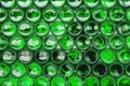 Glass bottles green. Green glass bottles of beer. Wall formed by green bottles. Green bottles background. Empty Glass Royalty Free Stock Photo