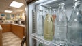 Glass bottles inside a refrigerator in a kitchen setting. Royalty Free Stock Photo
