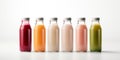 Glass bottles with juice and smoothies of different colors isolated on a white background Royalty Free Stock Photo