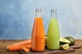Bottles with tasty juices and ingredients on table Royalty Free Stock Photo