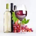 Glass, bottles of wine and grapes Royalty Free Stock Photo