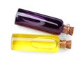 Glass bottles with yellow and purple food coloring on white background, top view Royalty Free Stock Photo