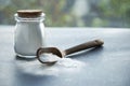 Glass bowl of baking soda. Spoonful of bicarbonate. Royalty Free Stock Photo