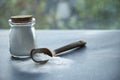 Glass bowl of baking soda. Spoonful of bicarbonate. Royalty Free Stock Photo