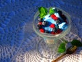 Glass bowl with blue ice cream on crocheted tablecloth