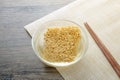 Glass bowl , chopsticks and instant noodle on the wooden table Royalty Free Stock Photo