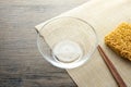 Glass bowl , chopsticks and instant noodle on the wooden table Royalty Free Stock Photo