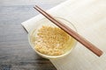 Glass bowl , chopsticks and instant noodle on the wooden table Royalty Free Stock Photo