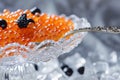 A glass bowl contains a vibrant mix of orange and black beads, forming an eye-catching display, A luxurious spread of caviar