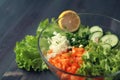 Glass bowl with cutted vegetables for a salad. Royalty Free Stock Photo