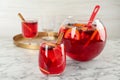 Glass and bowl of delicious aromatic punch drink on white marble table Royalty Free Stock Photo