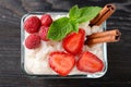 Glass bowl with delicious rice pudding and berries on black wooden table Royalty Free Stock Photo